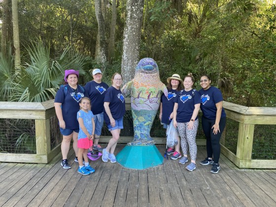 Pefcu group with Manatee statue
