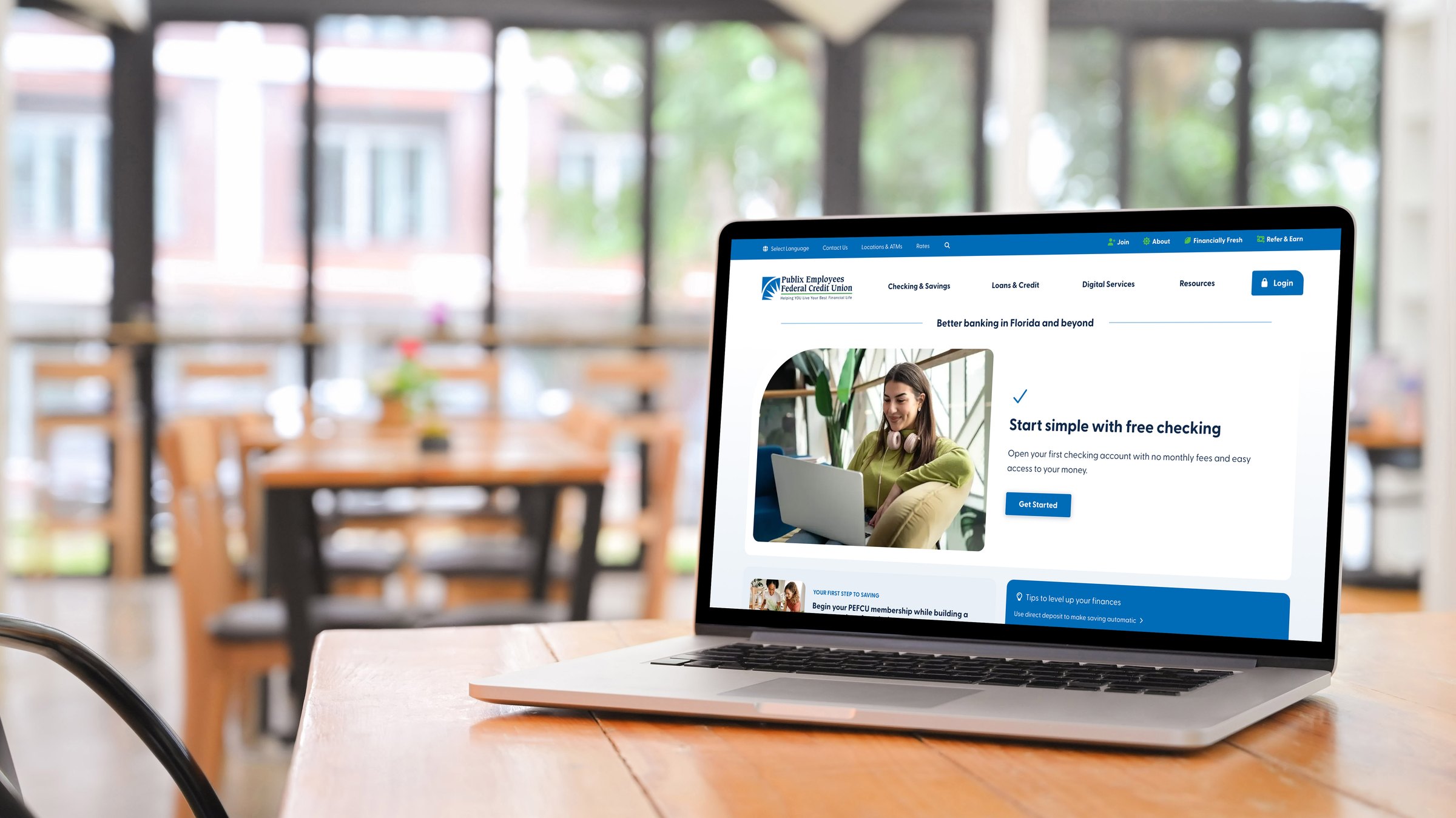 PEFCU's redesigned home page displayed on a laptop
